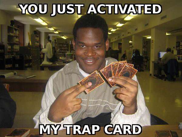 A man playing Yu-Gi-Oh and deviously smiling. The image has the macro text "YOU JUST ACTIVATED MY TRAP CARD" on it.